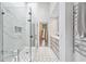Elegant bathroom featuring a glass-enclosed shower, double vanity, and heated towel rack providing a spa-like experience at 3776 Powers Ferry Nw Rd, Atlanta, GA 30342