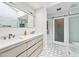 Well-lit bathroom featuring dual sinks, modern fixtures, and a glass-enclosed shower, exuding contemporary luxury at 3776 Powers Ferry Nw Rd, Atlanta, GA 30342
