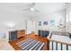Bright bedroom featuring a ceiling fan, hardwood floors, shutters, a crib and a changing table at 3776 Powers Ferry Nw Rd, Atlanta, GA 30342