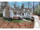 Charming gray home with a stone chimney and a welcoming front porch with a stone walkway at 3776 Powers Ferry Nw Rd, Atlanta, GA 30342