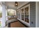 Inviting front porch with a swing, stylish lighting, and views of the surrounding trees at 3776 Powers Ferry Nw Rd, Atlanta, GA 30342