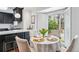 Eat-in kitchen features a round table, bay window, and a view of the backyard at 3776 Powers Ferry Nw Rd, Atlanta, GA 30342