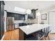 Elegant kitchen featuring stainless steel appliances, a large island, and sleek dark cabinetry at 3776 Powers Ferry Nw Rd, Atlanta, GA 30342