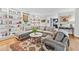 Spacious living room featuring a fireplace, hardwood floors, built-in shelving, and comfortable seating at 3776 Powers Ferry Nw Rd, Atlanta, GA 30342