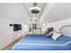 Comfortable bedroom features white paneled walls, a tv, and a staircase to the upper level at 3776 Powers Ferry Nw Rd, Atlanta, GA 30342