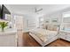 Bright main bedroom features hardwood floors, ceiling fan, and ensuite bath, promoting a comfortable and luxurious living space at 3776 Powers Ferry Nw Rd, Atlanta, GA 30342