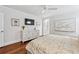 Bright main bedroom with ceiling fan, hardwood floors and a television creating an inviting and relaxing space at 3776 Powers Ferry Nw Rd, Atlanta, GA 30342