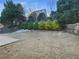 Large backyard with mature trees and a stone patio at 412 Pine Log Ct, Canton, GA 30115