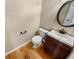 Cozy half-bathroom features a modern sink and a circular mirror, enhancing the room's stylish aesthetic at 412 Pine Log Ct, Canton, GA 30115