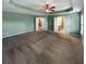 Large bedroom boasts plush carpet, recessed ceiling, and multiple doorways for easy access at 412 Pine Log Ct, Canton, GA 30115