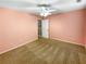 Spacious bedroom features neutral carpet, a ceiling fan, and ample space, providing a relaxing atmosphere at 412 Pine Log Ct, Canton, GA 30115