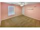 Cozy bedroom with neutral carpet, ceiling fan and simple decor, offering a comfortable retreat at 412 Pine Log Ct, Canton, GA 30115