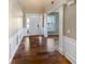 Inviting foyer featuring hardwood floors, white wainscoting, and a bright entryway, creating a warm welcome at 412 Pine Log Ct, Canton, GA 30115