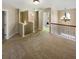 Upstairs hallway with carpet, a chandelier, and an adjacent laundry room at 412 Pine Log Ct, Canton, GA 30115