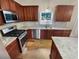 Beautiful kitchen with stainless steel appliances, granite countertops, and warm wooden cabinetry at 412 Pine Log Ct, Canton, GA 30115