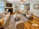 Staged living room with hardwood floors, fireplace, and cozy furniture at 412 Pine Log Ct, Canton, GA 30115