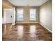 Bright living room featuring hardwood floors, white trim, and lots of natural light from large windows at 412 Pine Log Ct, Canton, GA 30115