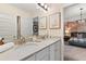 Elegant bathroom with double vanity, framed art, and an open doorway to the bedroom at 420 Hatcher Ct, Hampton, GA 30228