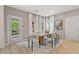 Bright and airy dining room with modern table, chairs, and decor at 420 Hatcher Ct, Hampton, GA 30228