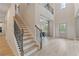 Grand two-story foyer featuring a staircase, hardwood floors, and an open view of the home's layout at 420 Hatcher Ct, Hampton, GA 30228