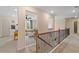Hallway with iron railing providing access to the other rooms in the house at 420 Hatcher Ct, Hampton, GA 30228