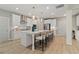 Spacious kitchen featuring a large island with seating, stainless steel appliances, and modern lighting at 420 Hatcher Ct, Hampton, GA 30228