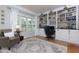 Cozy home office with built-in bookshelves, a comfortable chair, and natural light from the window at 5009 Preservation Pointe Nw, Kennesaw, GA 30152