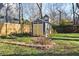 Backyard features a shed with yellow doors, a garden area, and a wooden fence, offering both utility and charm at 1095 Boulevard Se Dr, Atlanta, GA 30317