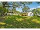 Lush backyard featuring a storage shed, mature trees, and plenty of green space at 1554 Pine Ct, Conley, GA 30288