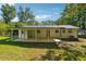 Well-maintained backyard showcasing a covered patio, lush lawn, and mature trees at 1554 Pine Ct, Conley, GA 30288