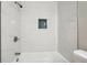 Bright bathroom showcasing marble-style tile and a shower niche with dark accents at 1554 Pine Ct, Conley, GA 30288