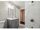 Modern bathroom with marble-style tile, a sleek gray vanity, and brushed nickel fixtures at 1554 Pine Ct, Conley, GA 30288