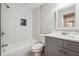 Bathroom with tiled shower, modern fixtures, and gray vanity for a relaxing retreat at 1554 Pine Ct, Conley, GA 30288