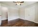 A cozy bedroom featuring hardwood floors, a ceiling fan, and a double-door closet at 1554 Pine Ct, Conley, GA 30288