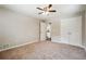 Neutral bedroom featuring plush carpet, a ceiling fan and large closet with white doors at 1554 Pine Ct, Conley, GA 30288