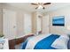 Bedroom boasts hardwood floors, a ceiling fan, and bright natural light at 1554 Pine Ct, Conley, GA 30288