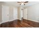 Bedroom features hardwood floors, a ceiling fan, and neutral color scheme at 1554 Pine Ct, Conley, GA 30288