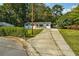 Charming home exterior featuring a driveway and well-manicured front lawn at 1554 Pine Ct, Conley, GA 30288