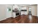 Modern kitchen with white cabinets, stainless steel appliances, and dark backsplash at 1554 Pine Ct, Conley, GA 30288