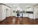 Gourmet kitchen featuring stainless steel appliances, white cabinetry, and hardwood flooring at 1554 Pine Ct, Conley, GA 30288