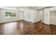 Open-concept living space with hardwood floors, neutral paint, and lots of natural light at 1554 Pine Ct, Conley, GA 30288