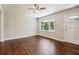 Sun-filled living room with beautiful hardwood floors and a large window at 1554 Pine Ct, Conley, GA 30288