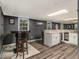 Finished basement featuring a wet bar area, countertop seating, and neutral flooring at 2982 Huntshire Pl, Atlanta, GA 30340