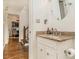 Powder room with granite counter and white cabinets at 2982 Huntshire Pl, Atlanta, GA 30340
