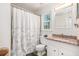 Bright bathroom featuring granite countertops, tile flooring, and a shower with decorative curtain at 2982 Huntshire Pl, Atlanta, GA 30340
