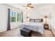 Cozy bedroom with neutral tones, ceiling fan, and large window providing natural light at 2982 Huntshire Pl, Atlanta, GA 30340