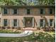 Attractive brick home featuring green shutters, a welcoming front door, and well-maintained landscaping at 2982 Huntshire Pl, Atlanta, GA 30340