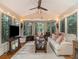 Bright and airy sunroom with vaulted ceilings, large windows, and cozy seating, perfect for relaxation at 2982 Huntshire Pl, Atlanta, GA 30340