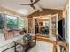 Cozy sunroom with brick accent wall, large windows, and comfortable seating, connecting to the dining area at 2982 Huntshire Pl, Atlanta, GA 30340