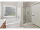 Bathroom with bathtub, standing shower and window, with a wooden vanity at 4677 Creekside Cv, Atlanta, GA 30349